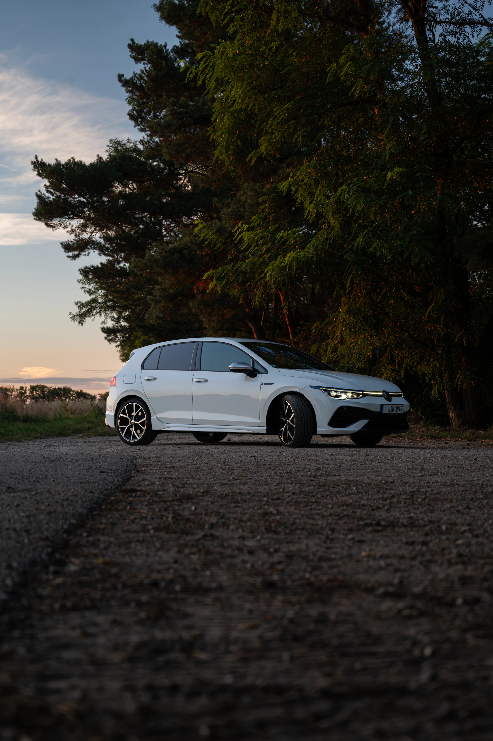 A white car parked on the side of a road