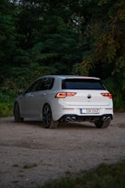 A white car parked on a gravel road