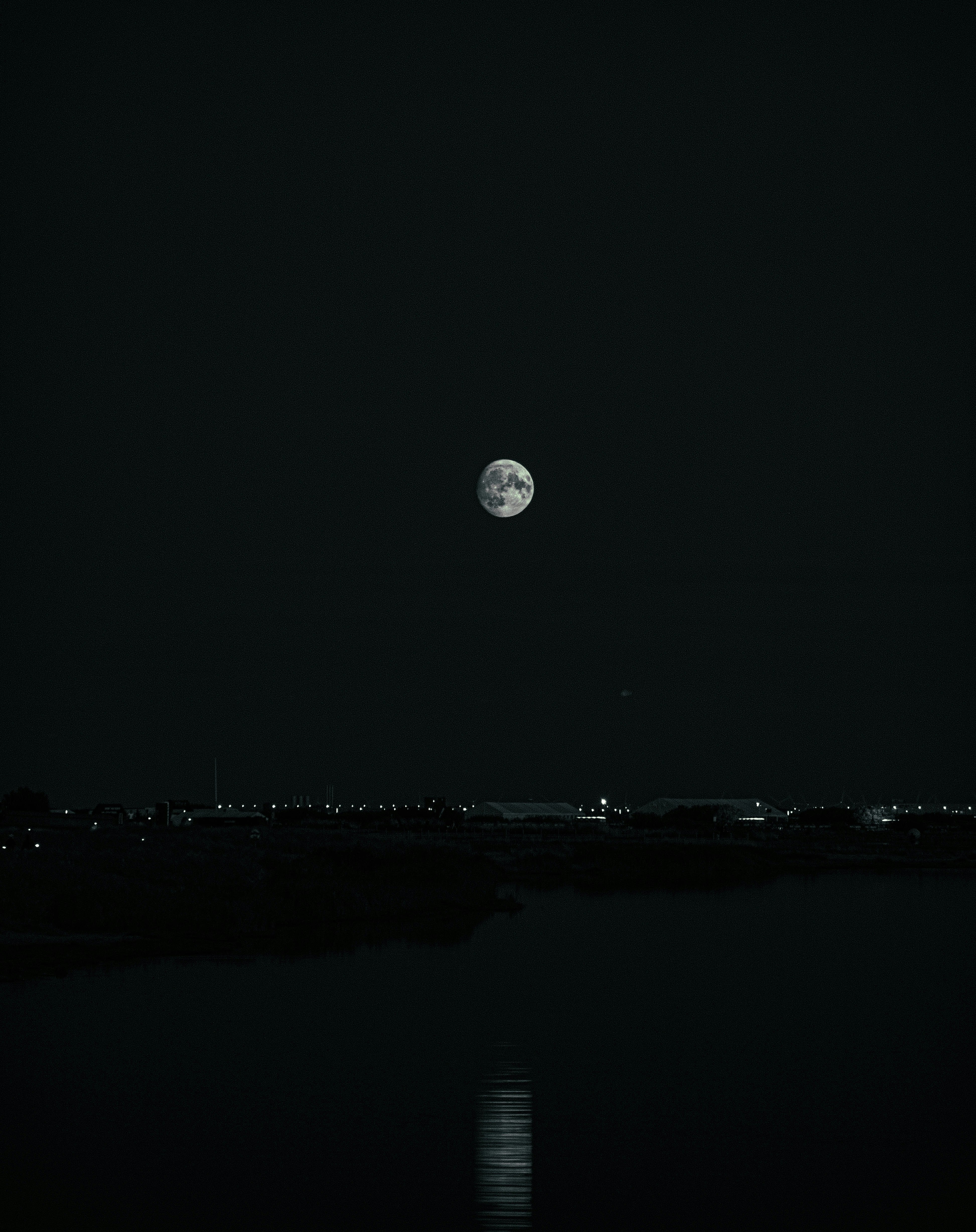 A black and white photo of a full moon