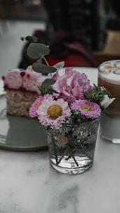A plate with a piece of cake and flowers on it