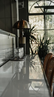 A kitchen with a table and chairs next to a window