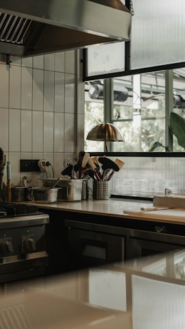 A kitchen with a stove top oven sitting next to a window