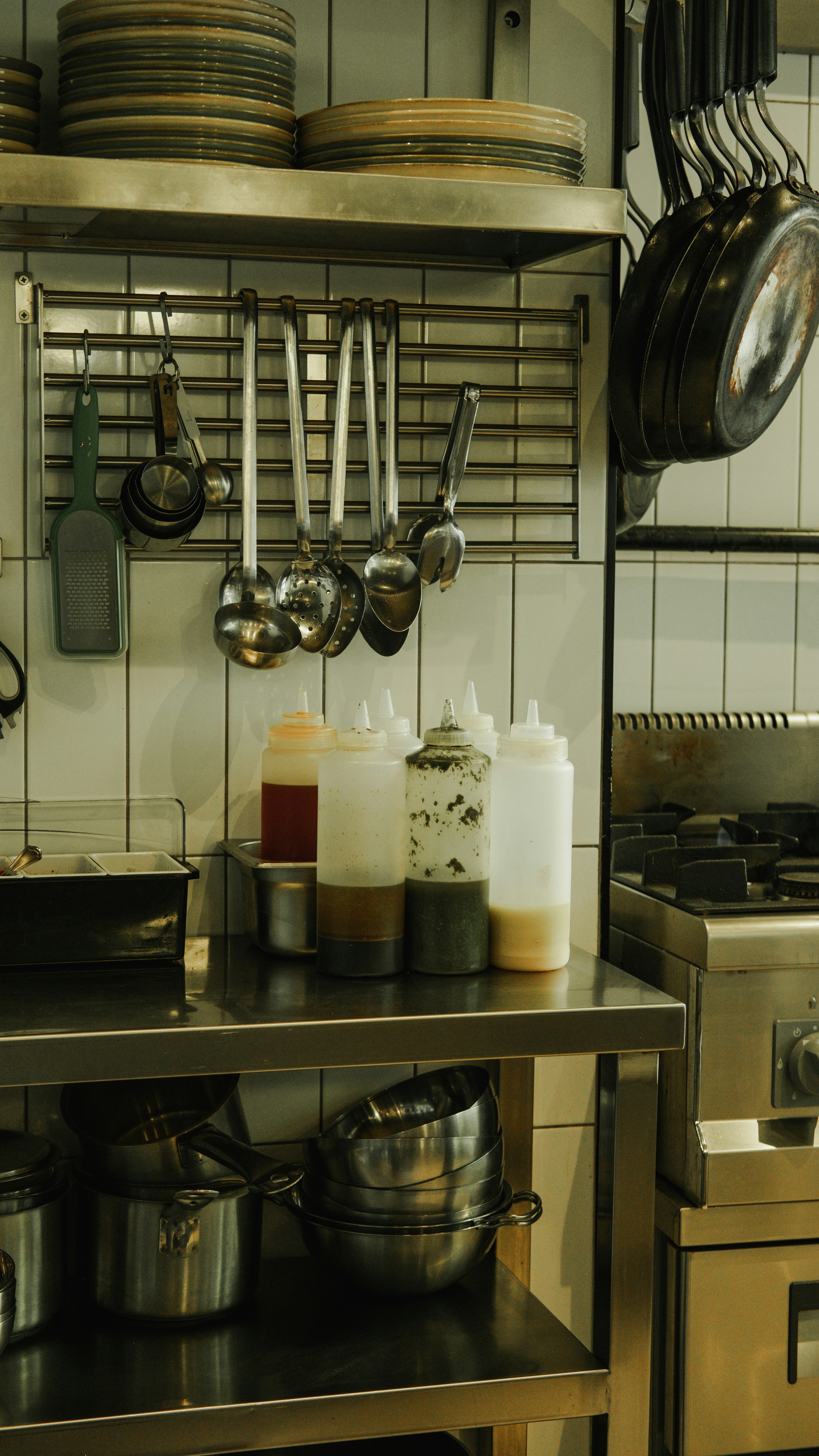 A kitchen with pots and pans hanging on the wall
