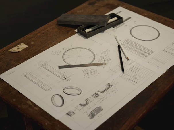 A wooden table topped with a piece of paper and a pair of scissors