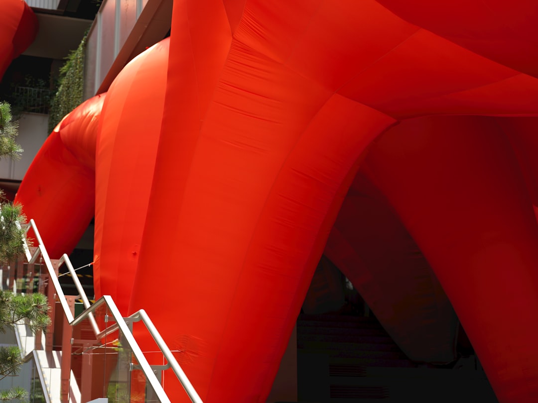 A large red balloon is in the air,