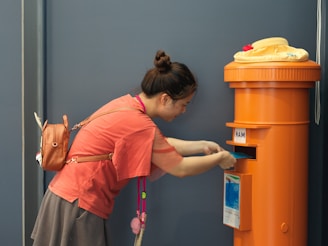 A woman standing next to a yellow post