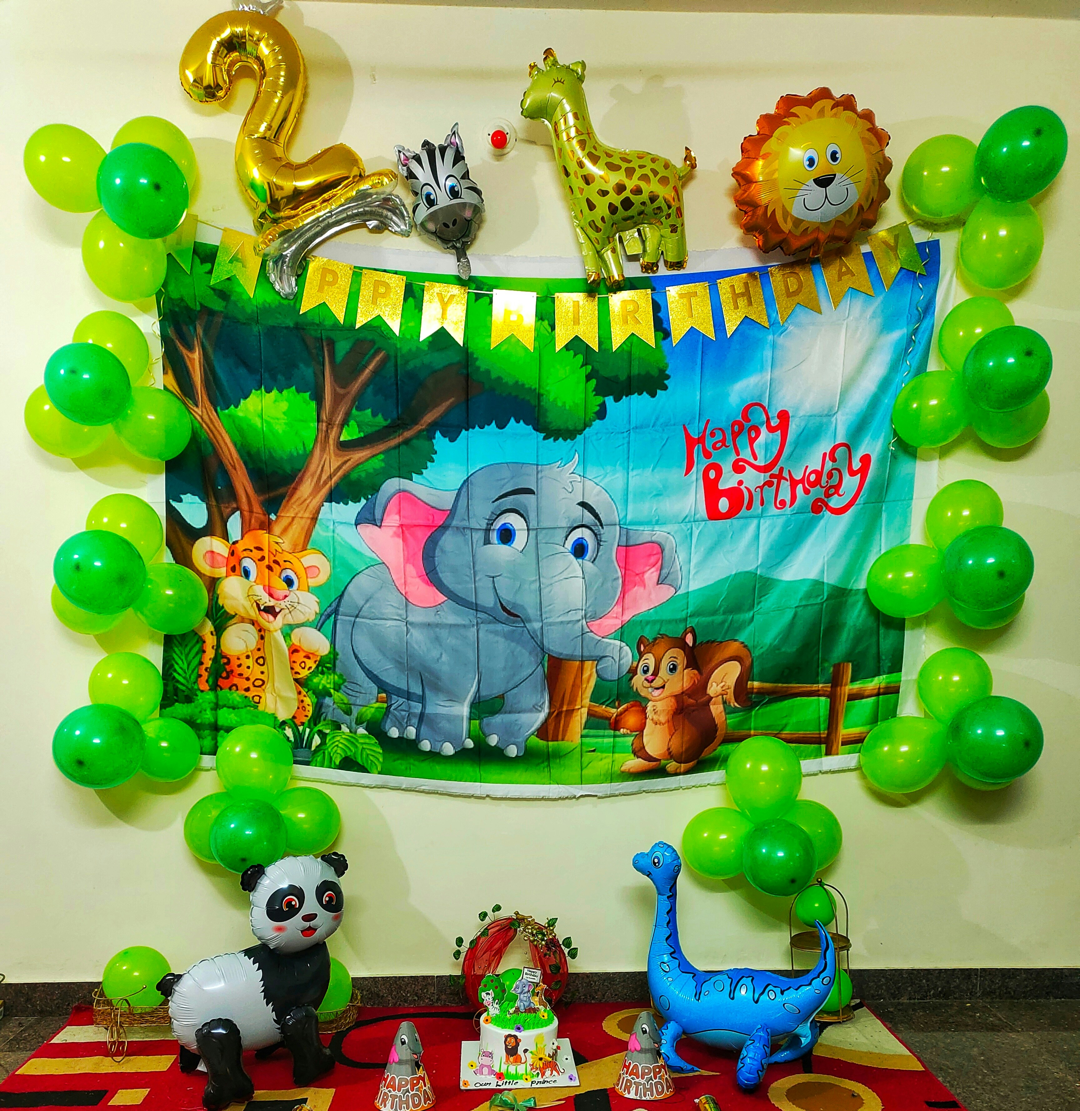 Kids birthday party with jungle theme decorations, green and yellow balloons in a bright playful space