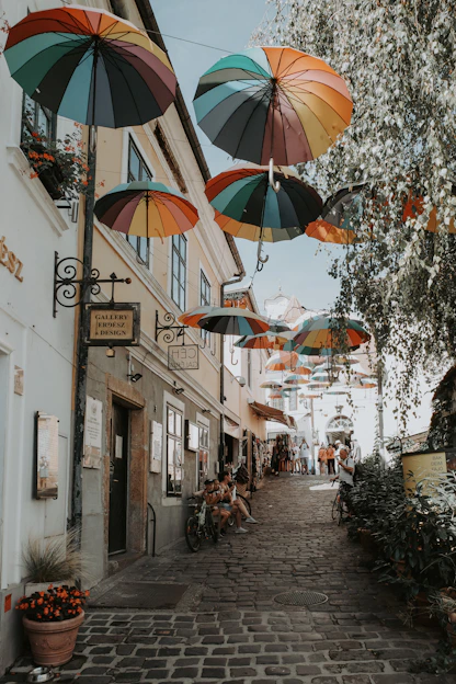 Several umbrellas hanging from the side of a building