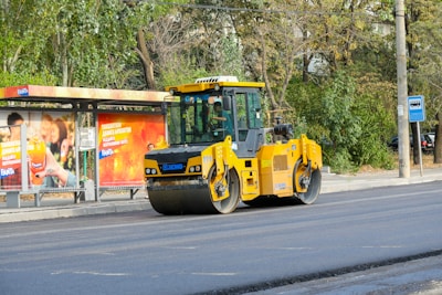 A yellow bulldozer is parked on the side of the road