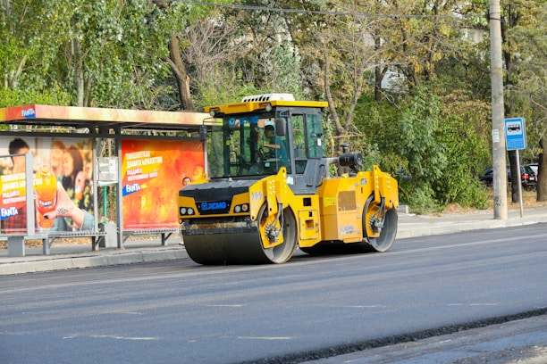 A yellow bulldozer is parked on the side of the road