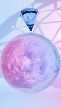 A pink and blue object in a glass bowl