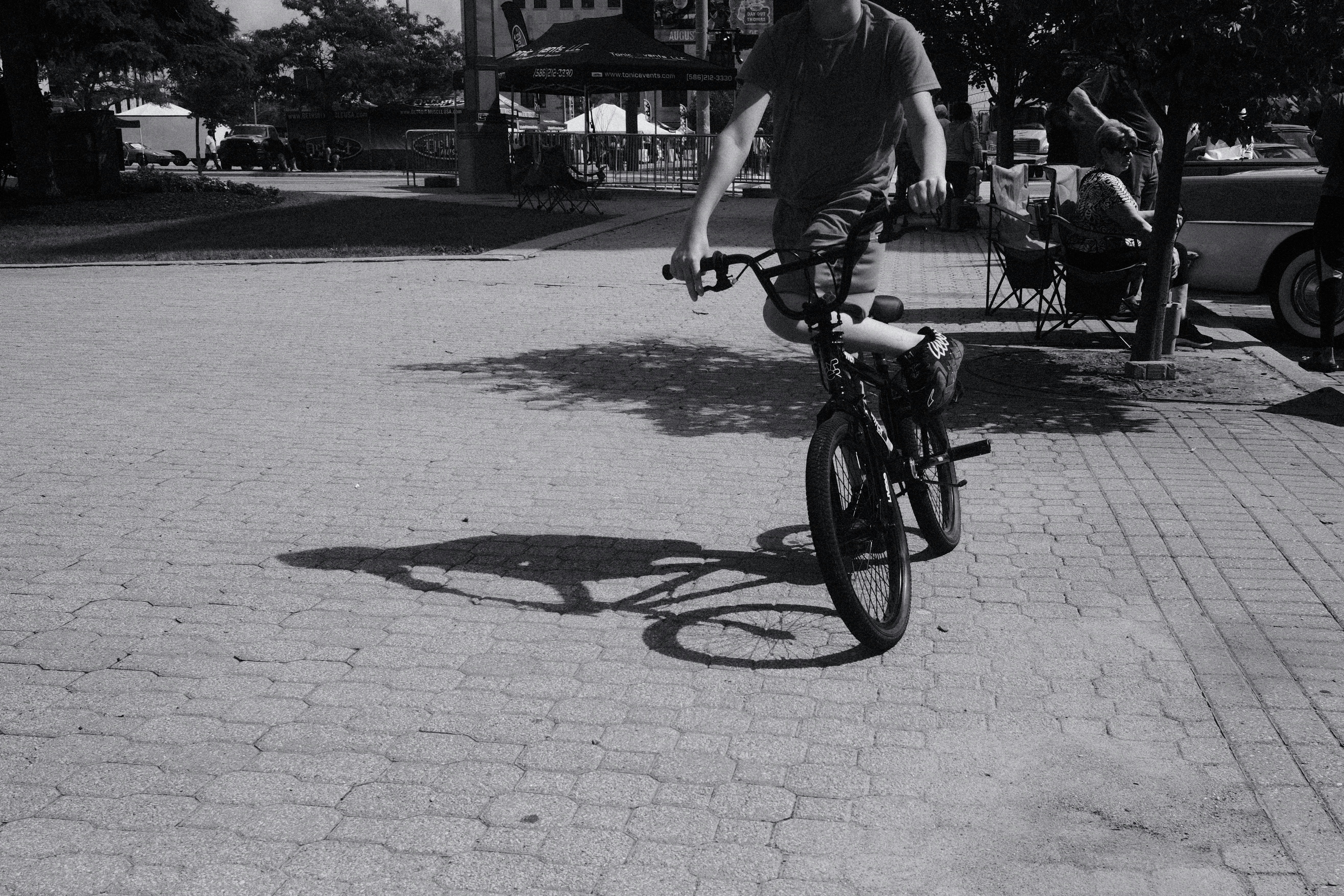 A man riding a bike down a street