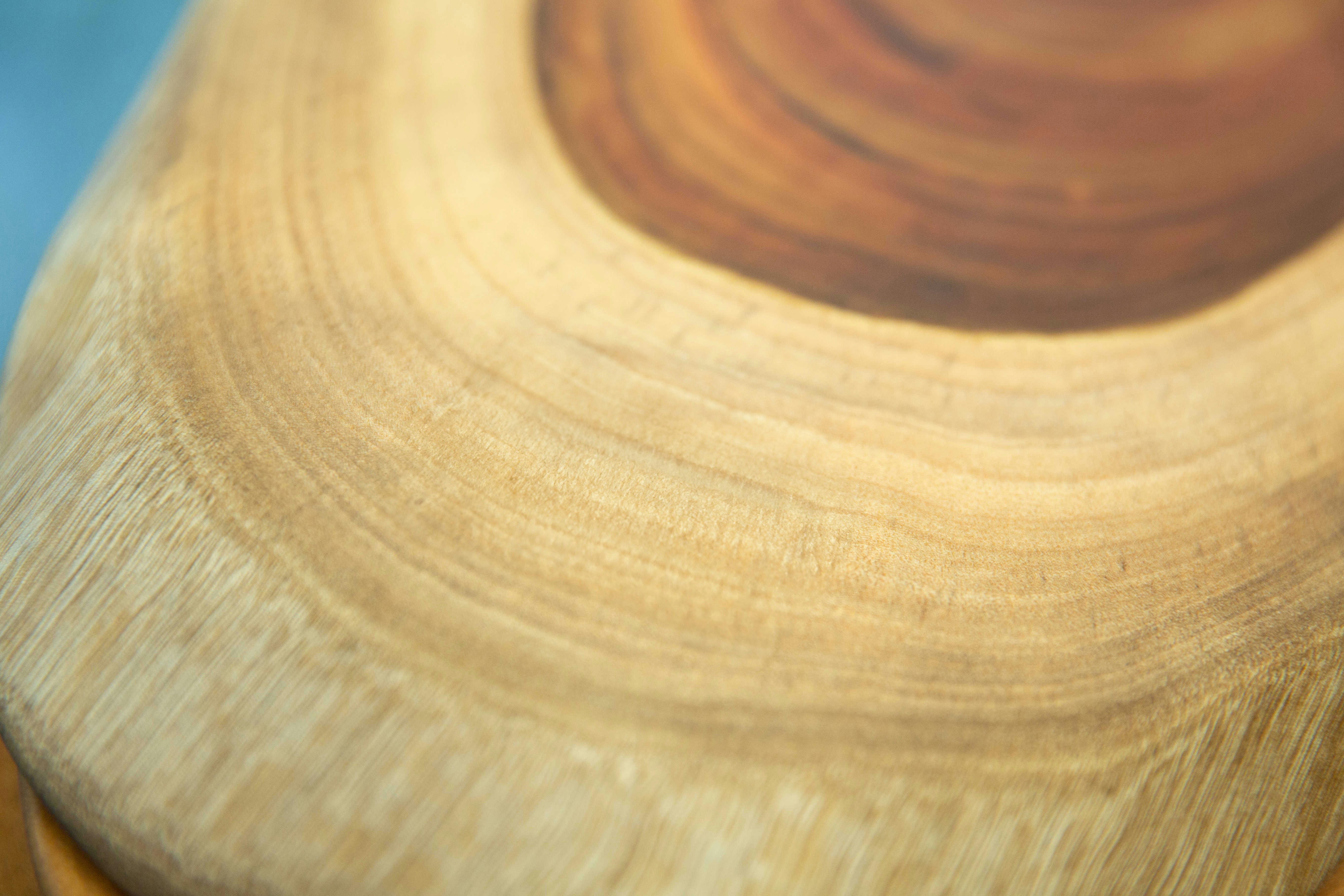 A close up of a wooden object with a blurry background