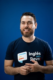 A man in a black shirt is holding his hands together