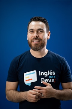 A man in a black shirt is holding his hands together