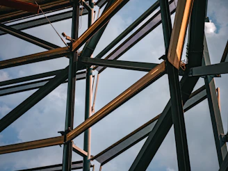 A close up of a metal structure with sky in the background