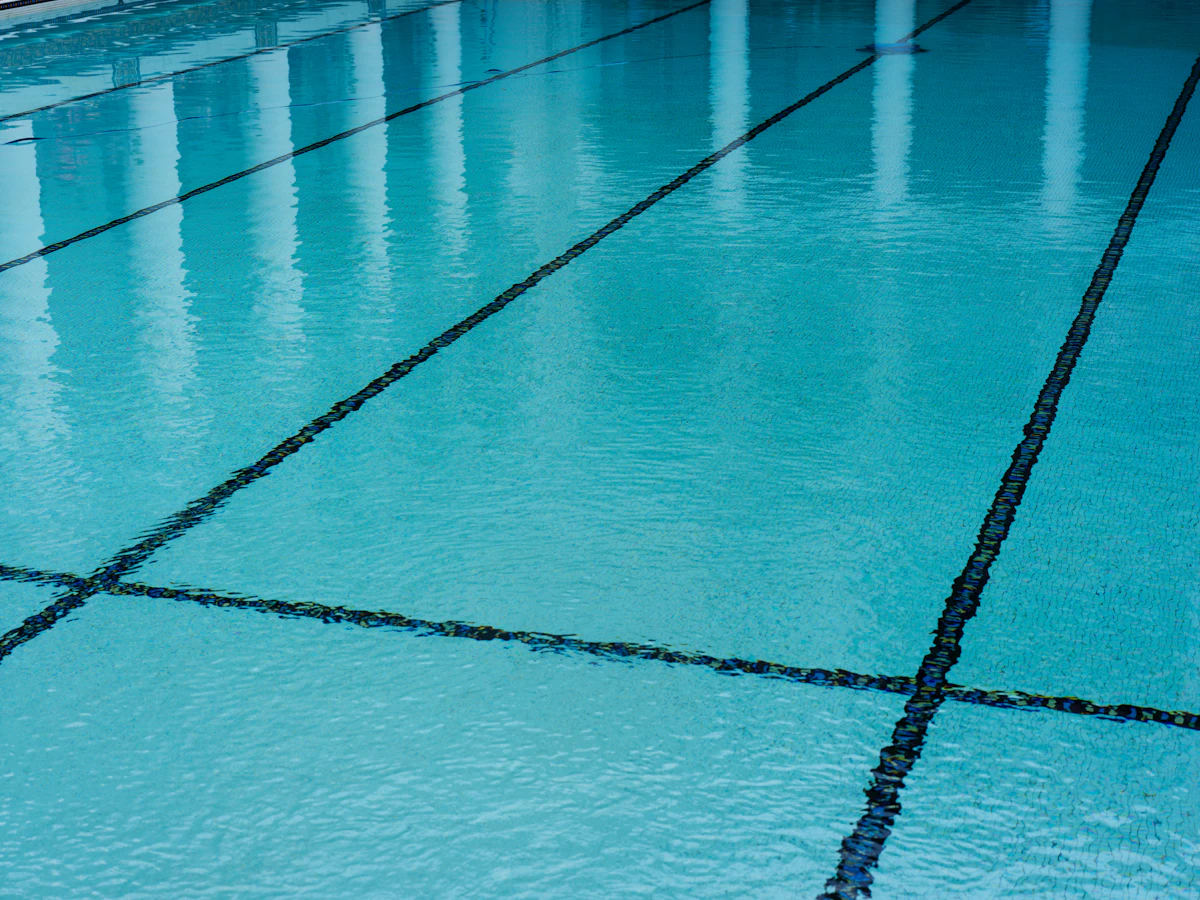 swimming pool with tiled floor and blue water