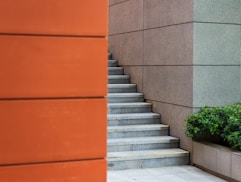 A man walking down a sidewalk next to a building