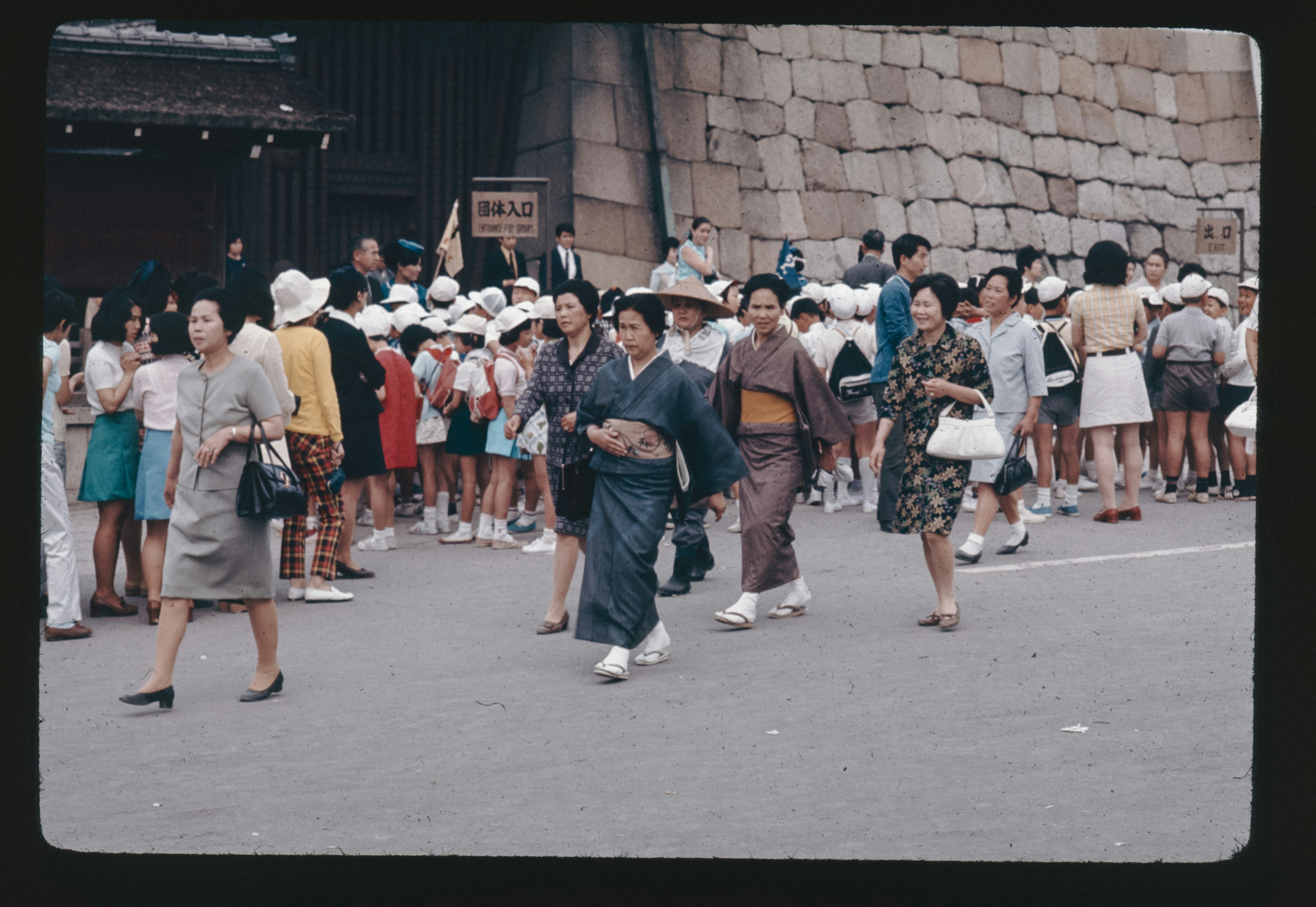 A group of people walking down a street