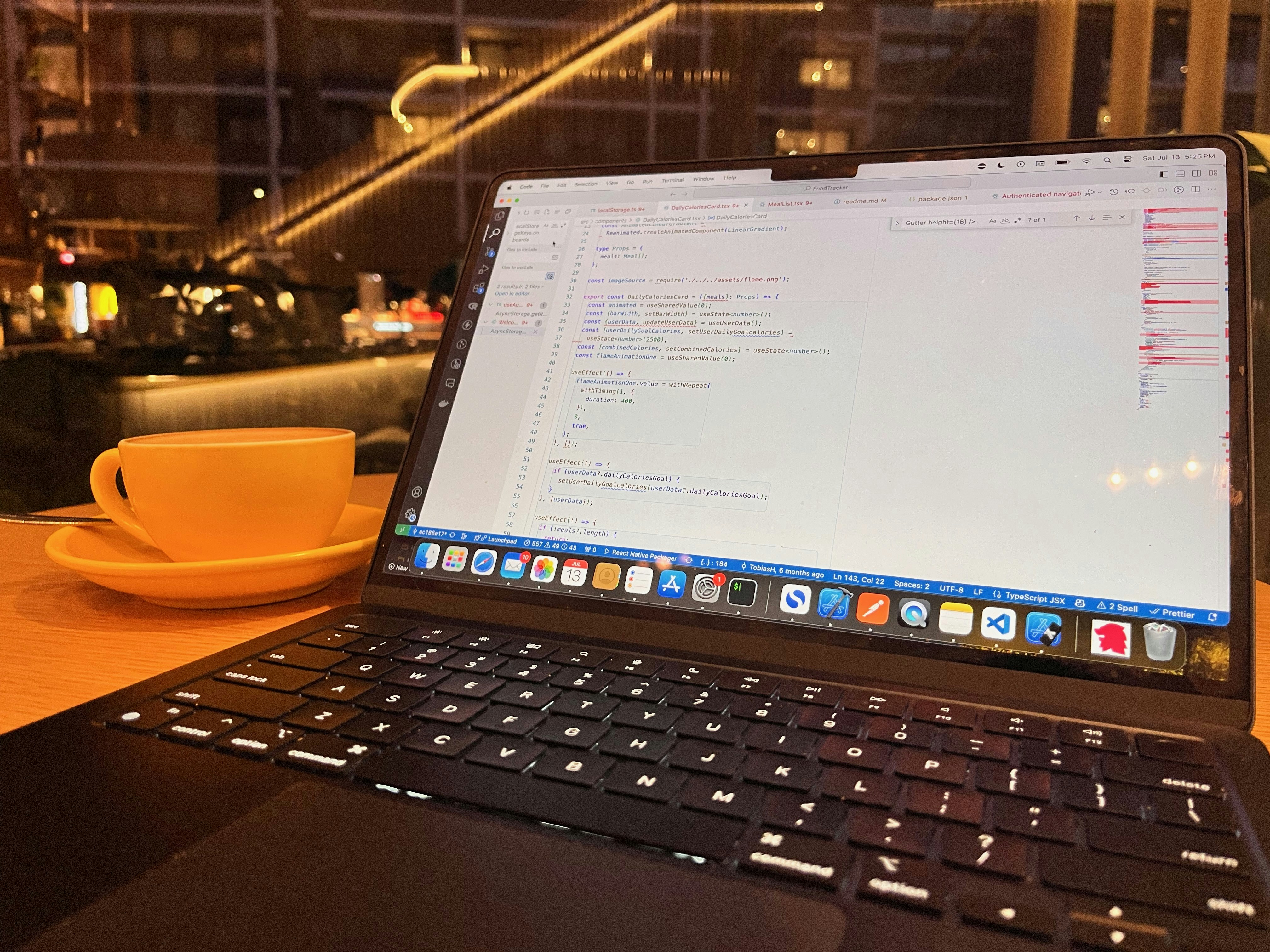 Java code on bright laptop screen with coffee cup and notebook in modern workspace