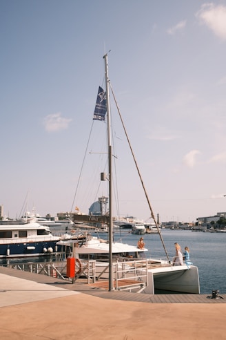 A boat docked at a pier with a flag on it