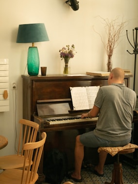 A man sitting at a piano in a living room