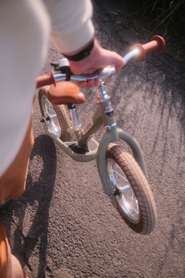 A person riding a bike on a dirt road