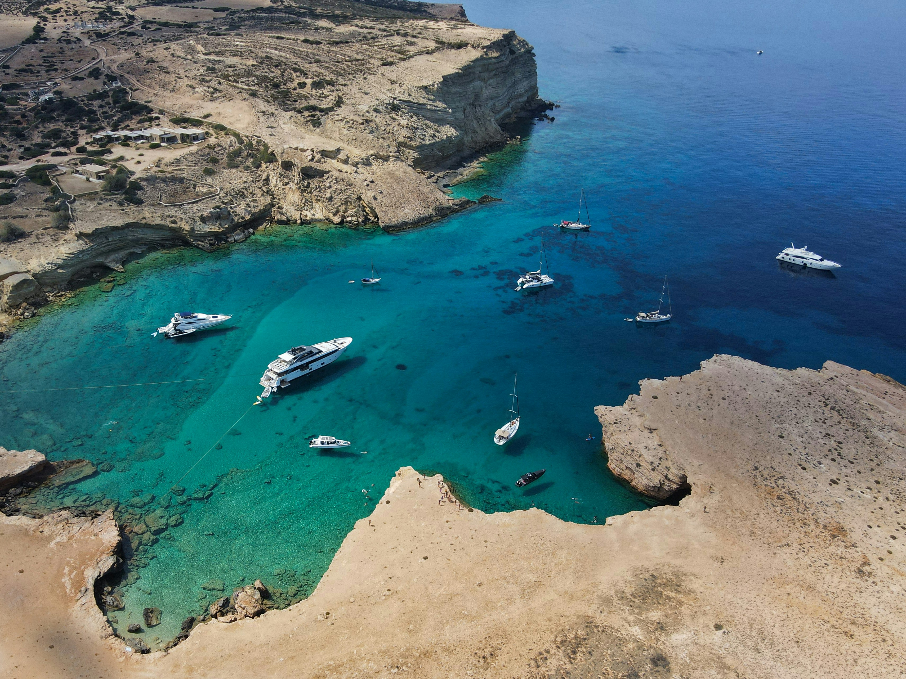 A group of boats floating on top of a body of water