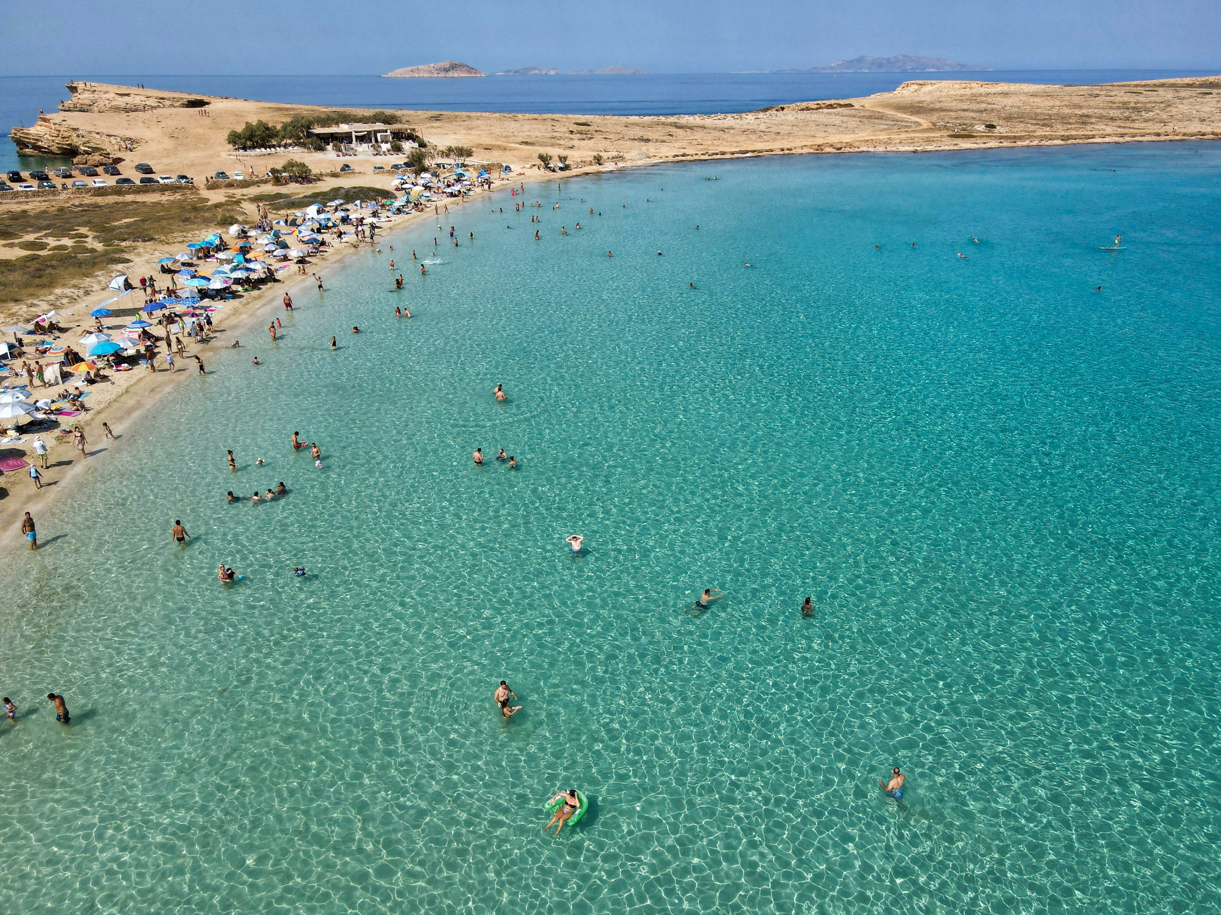 A large body of water next to a sandy beach