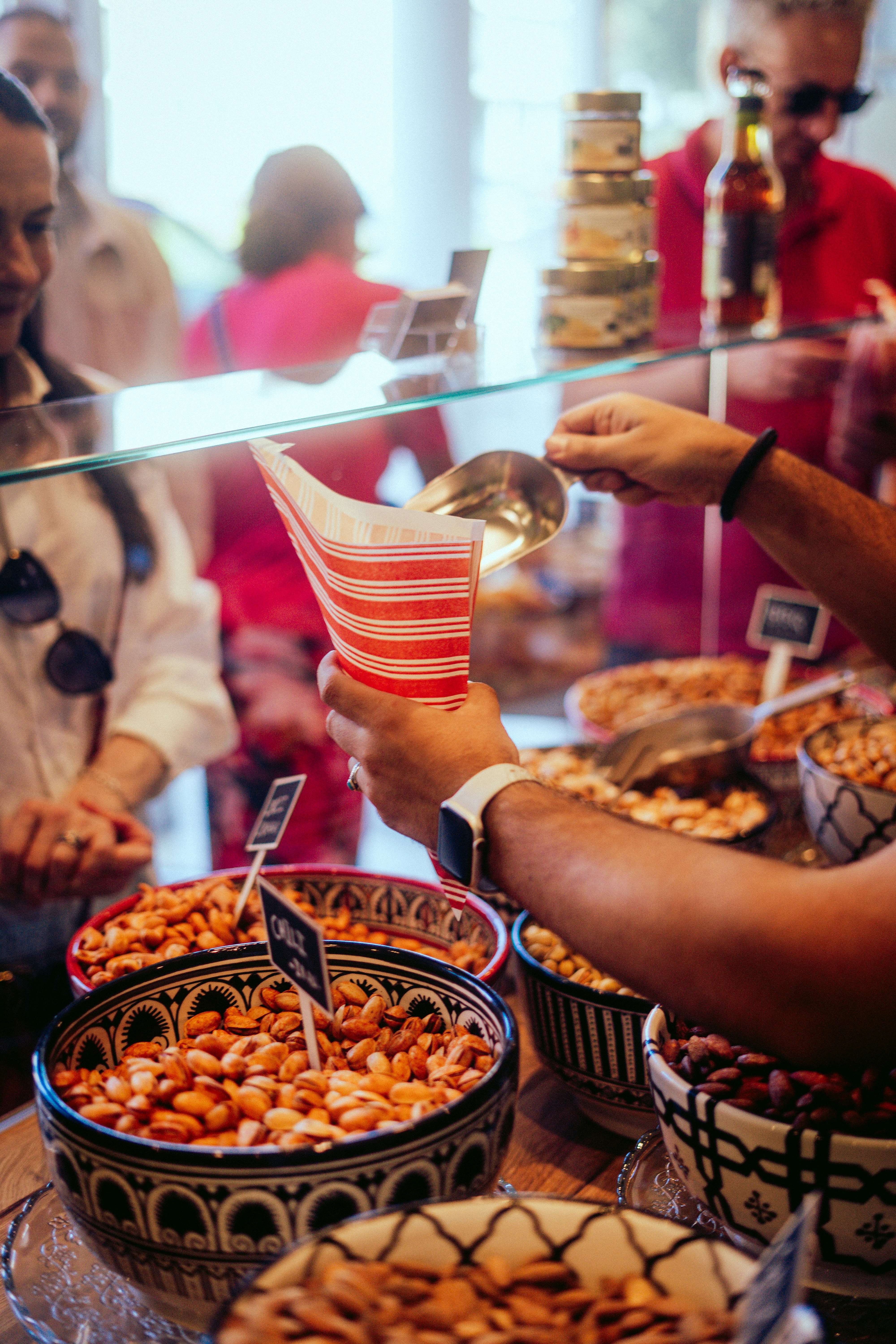 A group of people standing around a table filled with food photo – Free ...