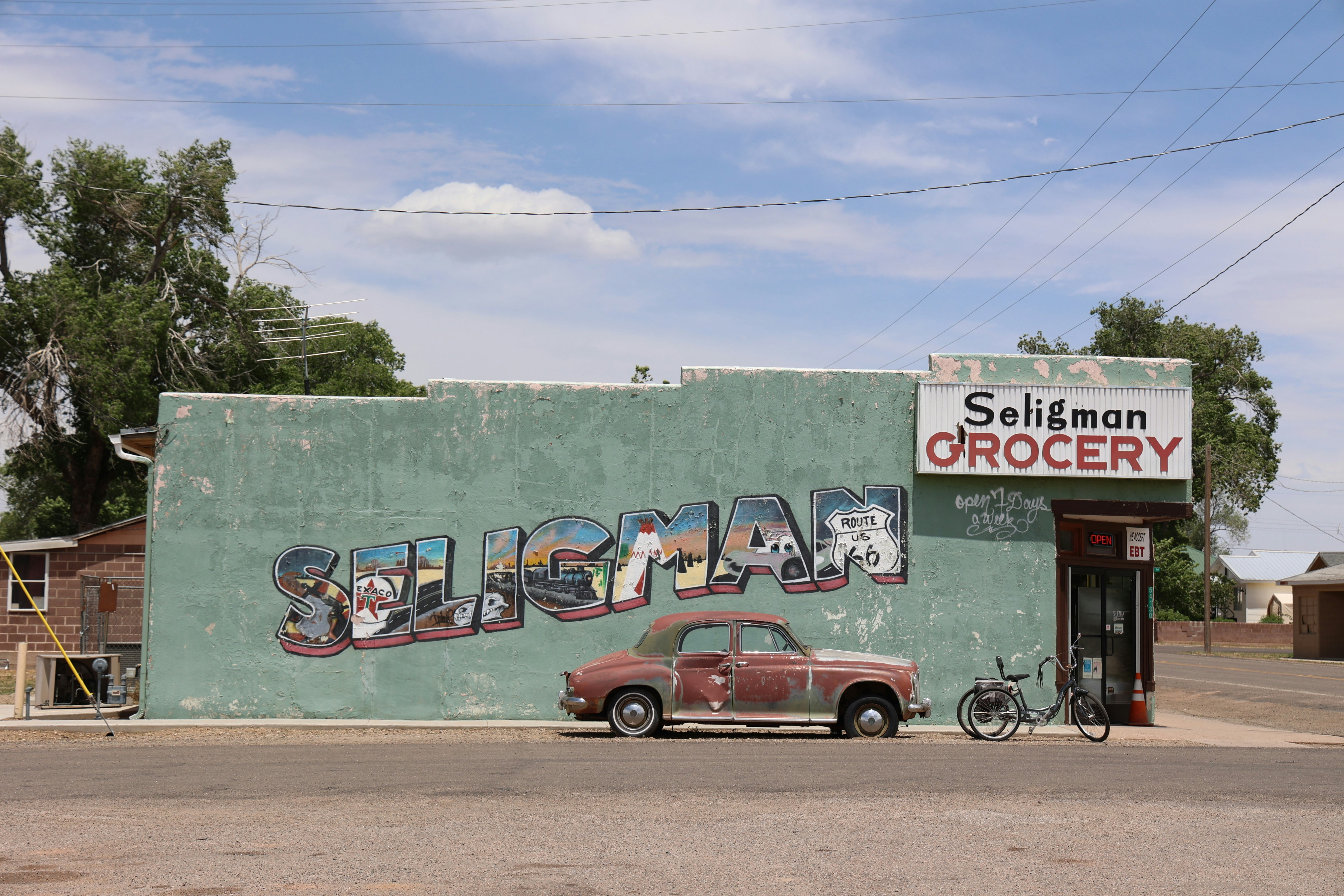 A car parked in front of a building with graffiti on it