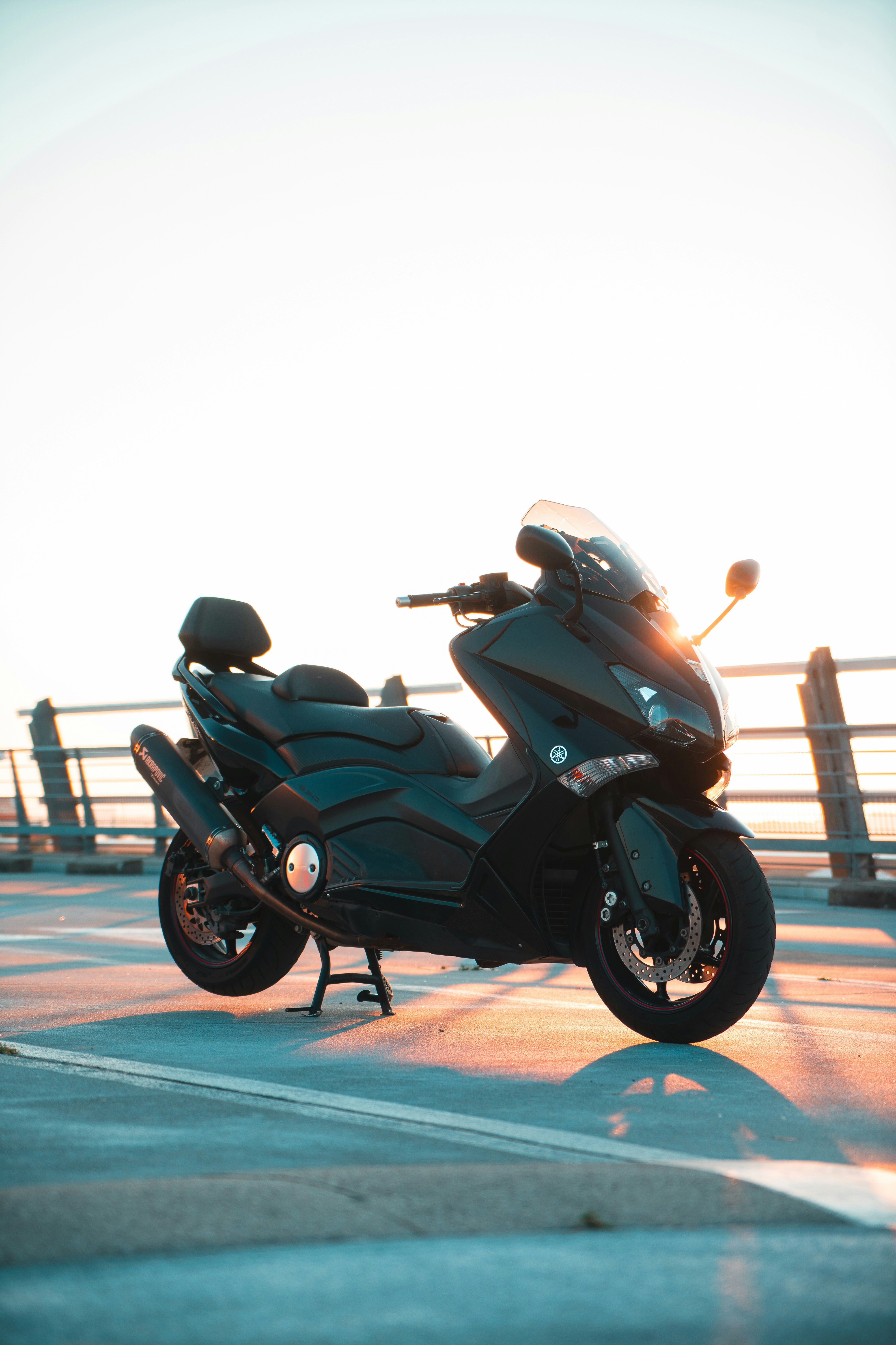 A black motorcycle parked on top of a parking lot