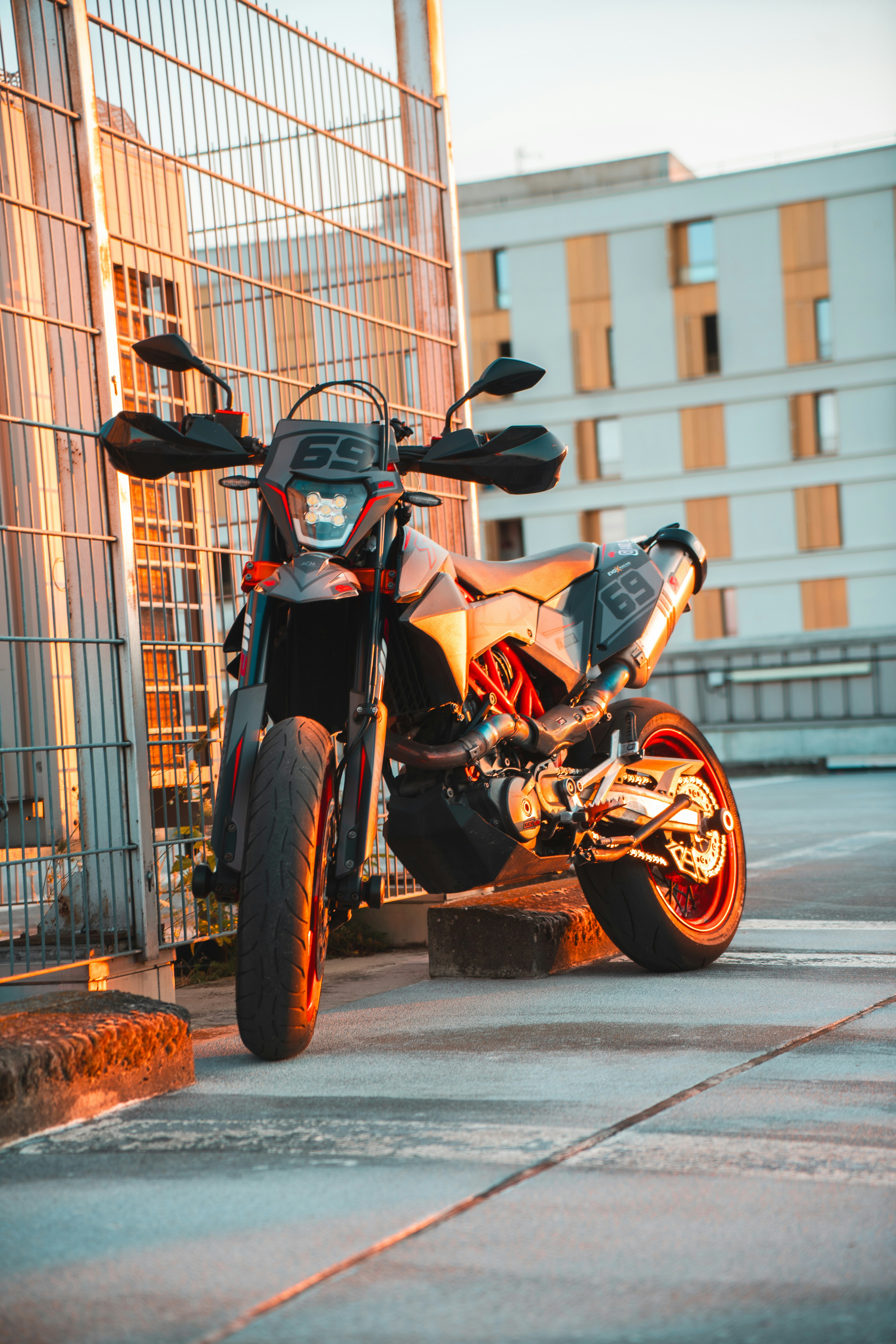 A motorcycle parked in a parking lot next to a building