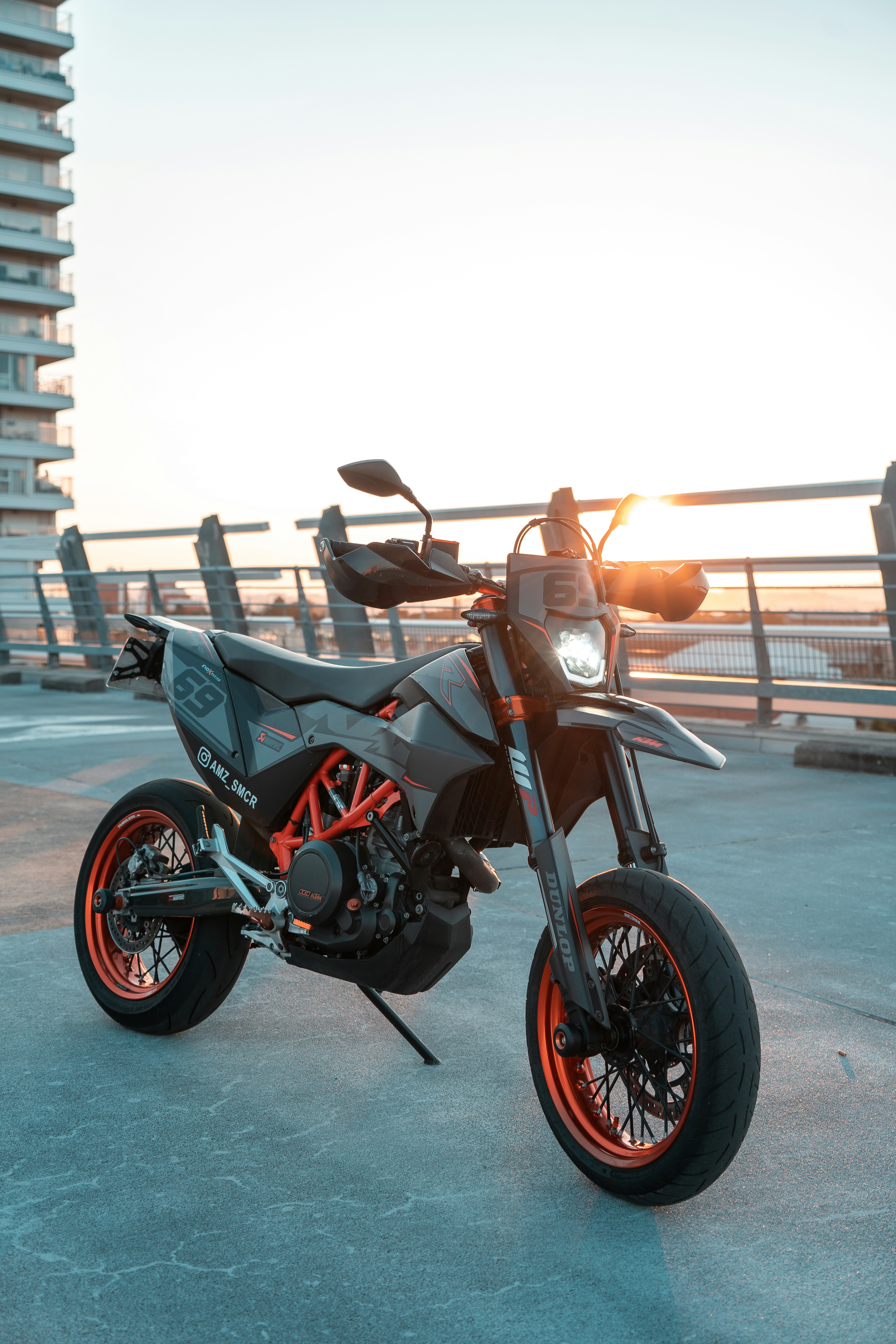 A motorcycle parked in front of a tall building