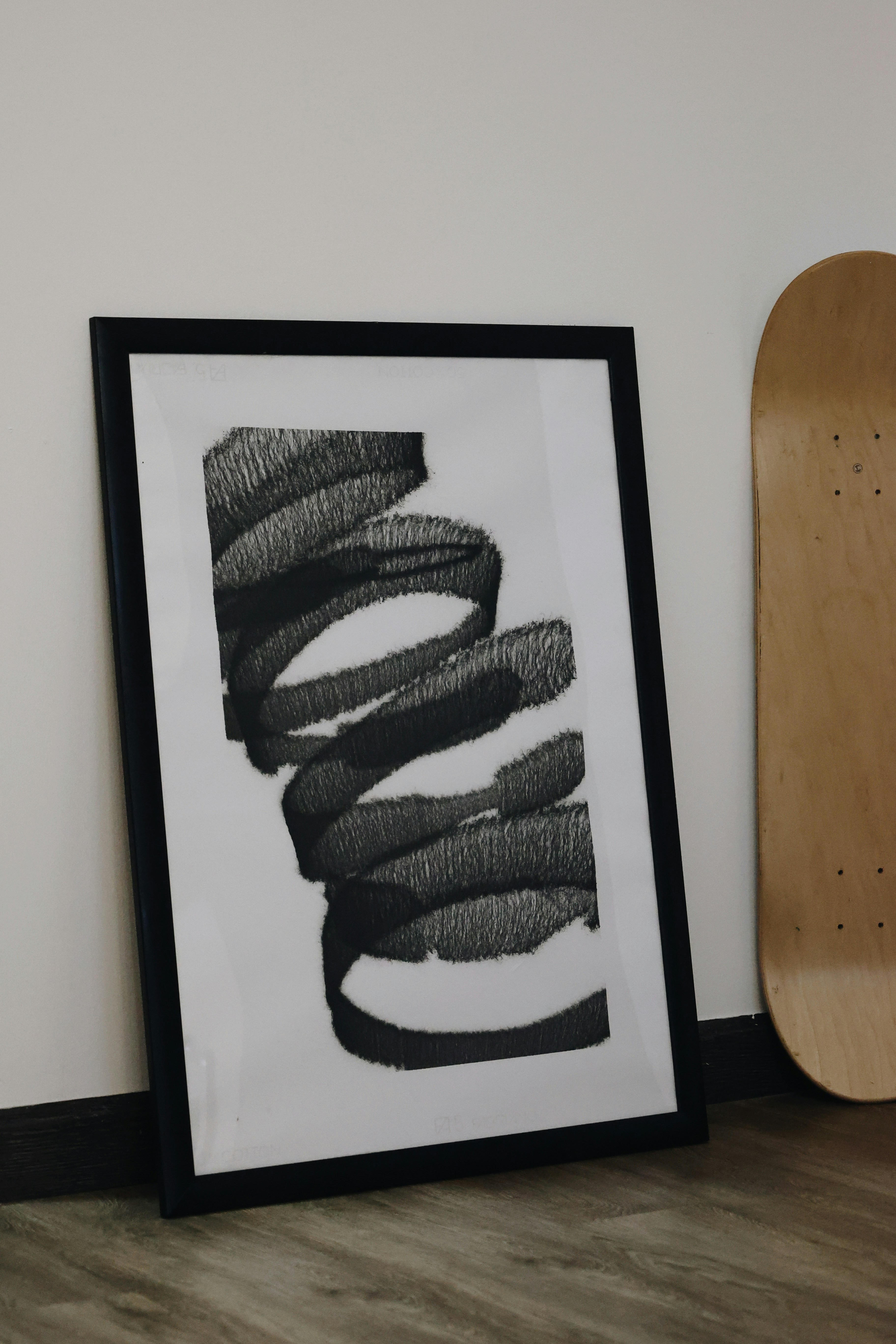 A picture of a skateboard next to a picture of a painting
