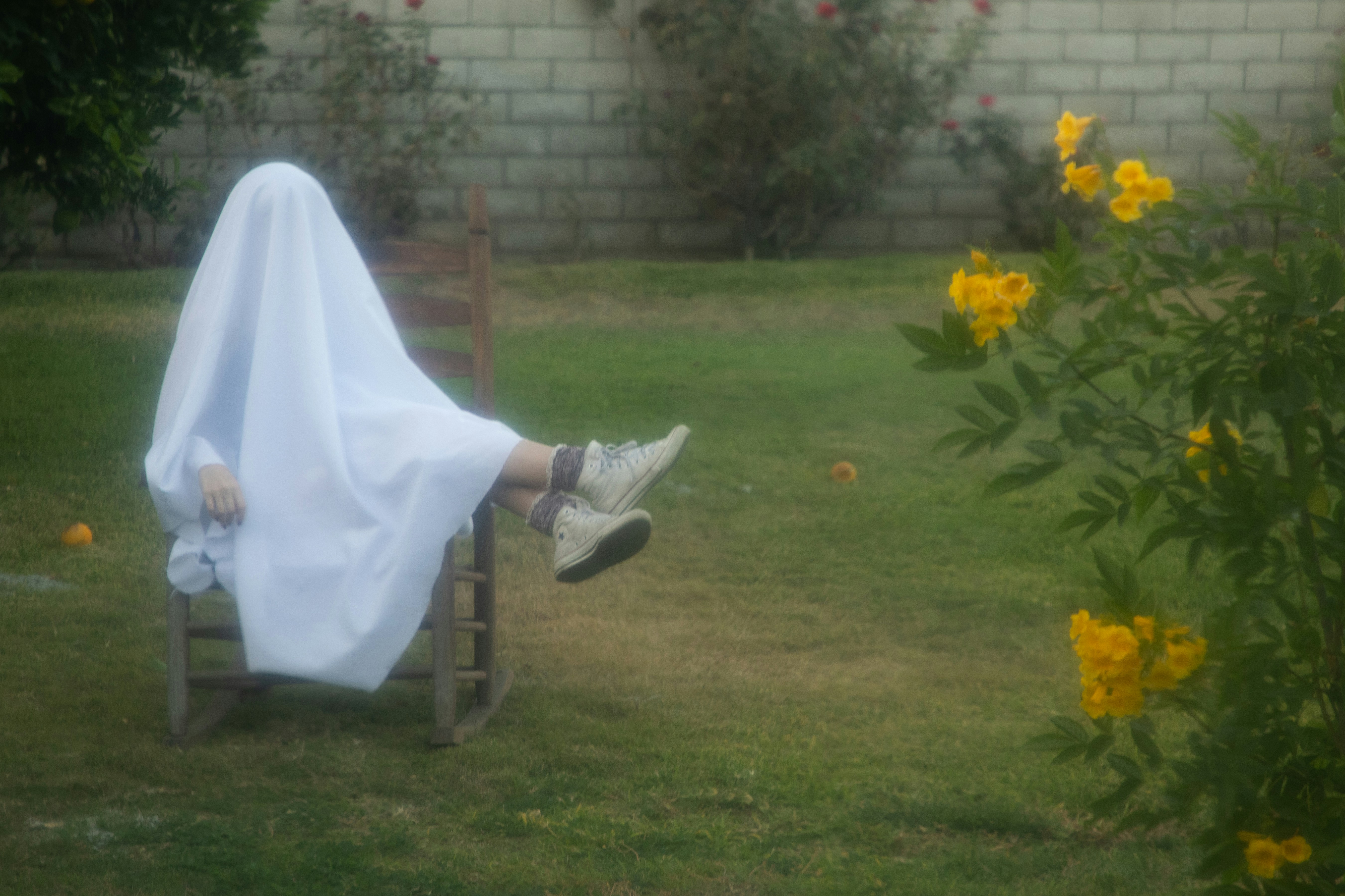 A person sitting in a chair covered in a blanket