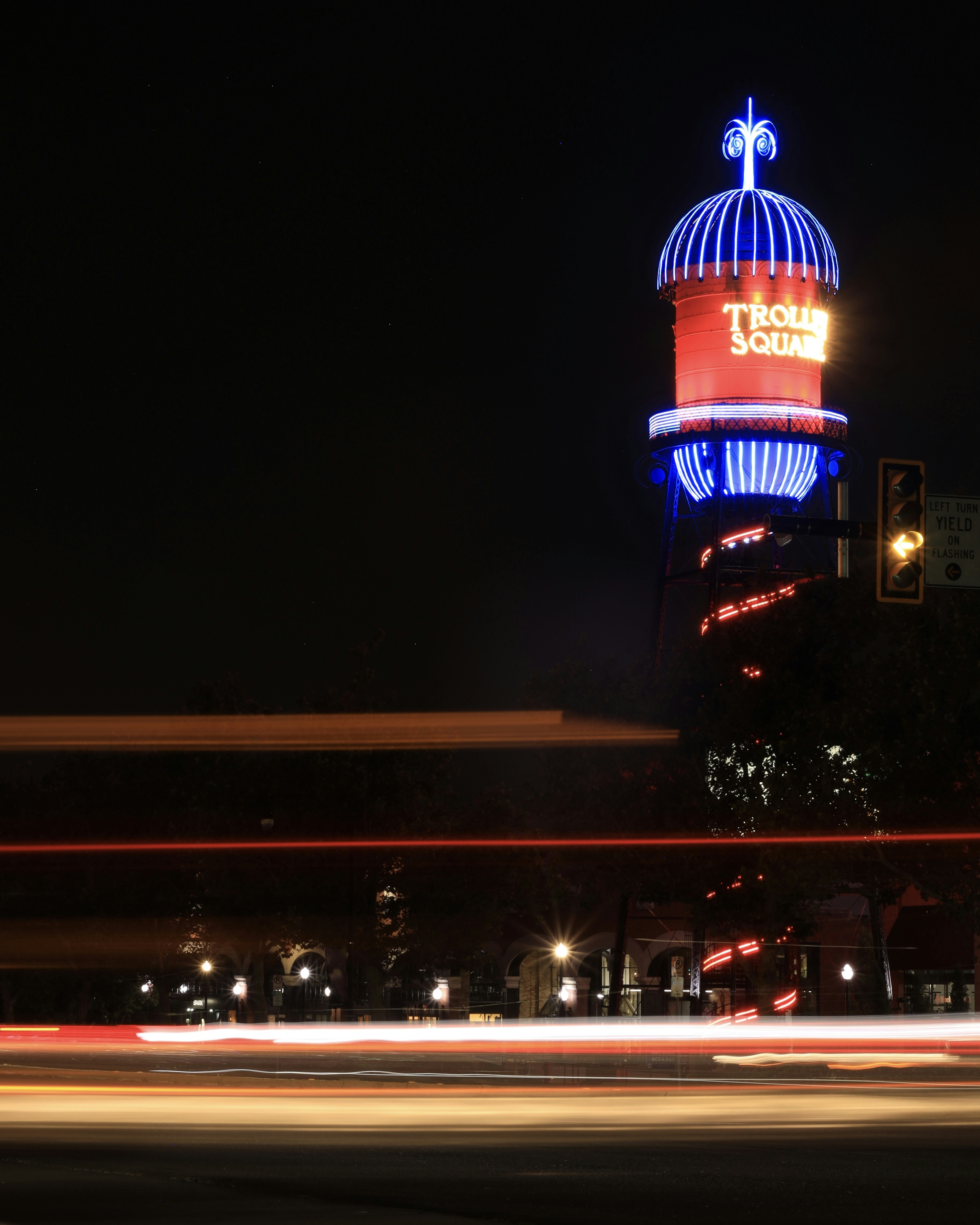 A tall building with a lit up dome at night
