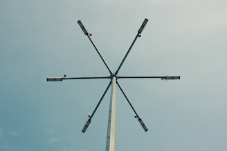 A tall pole with four antennas on top of it