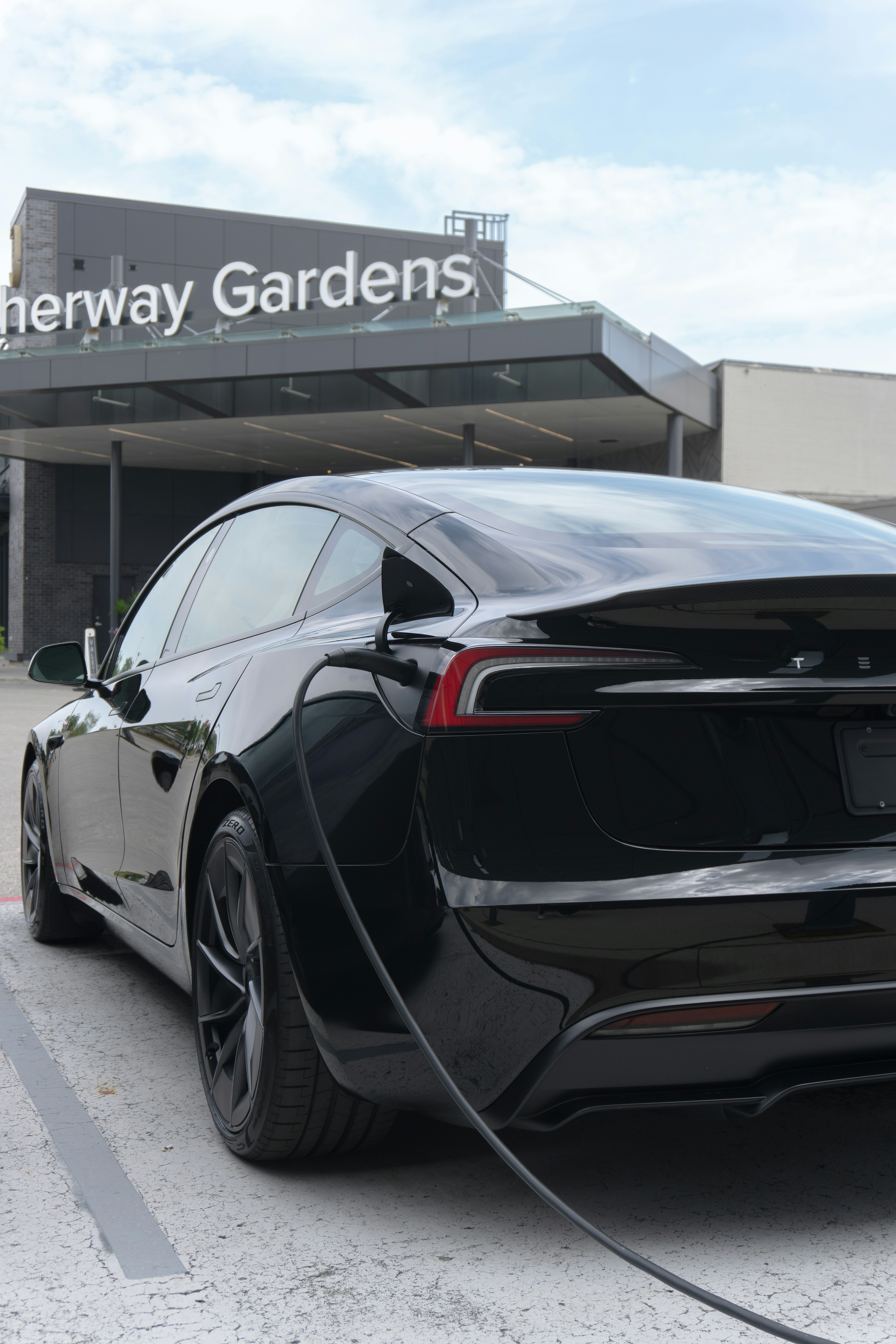An electric car plugged in to a charging station