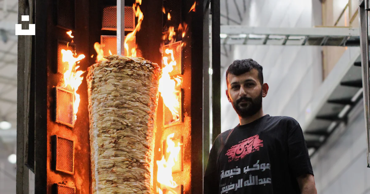 A man standing in front of a burning object photo – Free Karbala Image ...