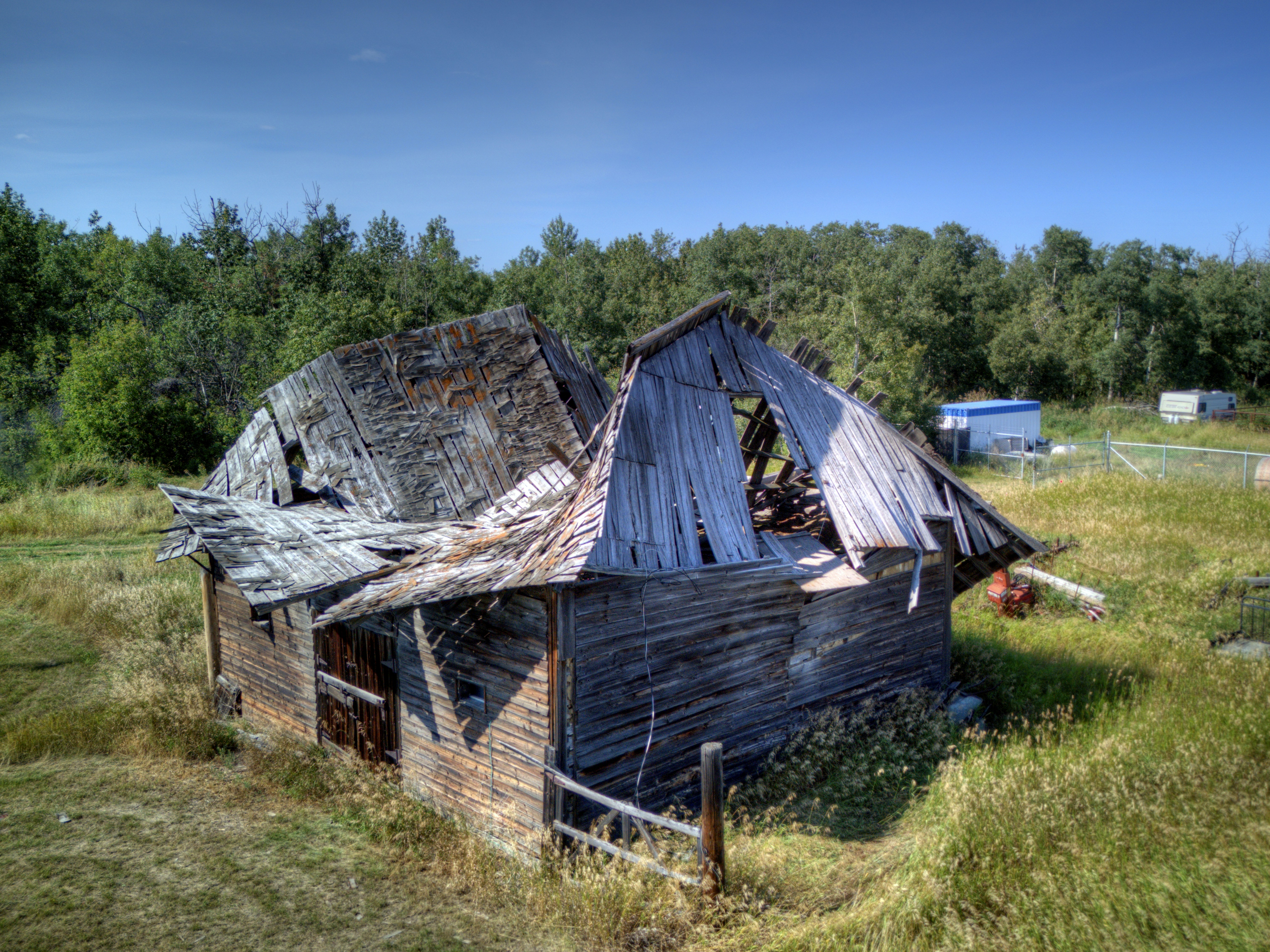 An old run down barn in a field
