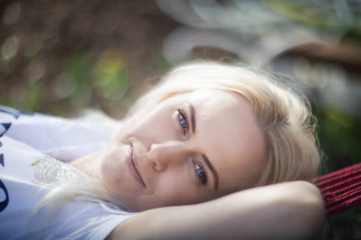 A woman laying on the ground with her eyes closed