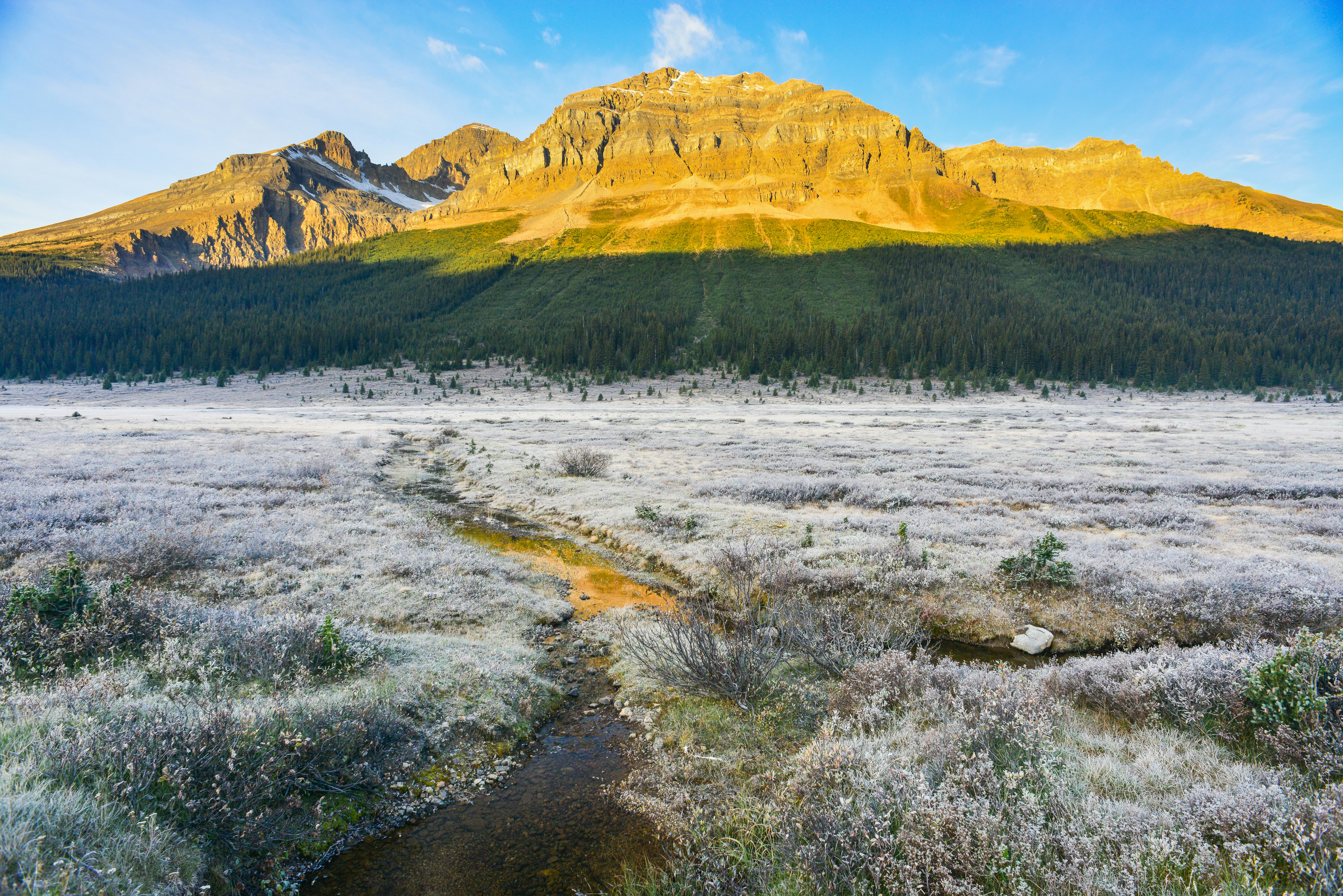 A view of a mountain with a river running through it