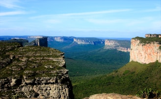 A scenic view of the blue mountains with a cliff in the foreground