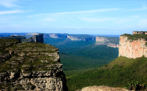A scenic view of the blue mountains with a cliff in the foreground