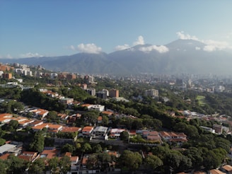 An aerial view of a city with mountains in the background