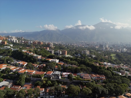 An aerial view of a city with mountains in the background