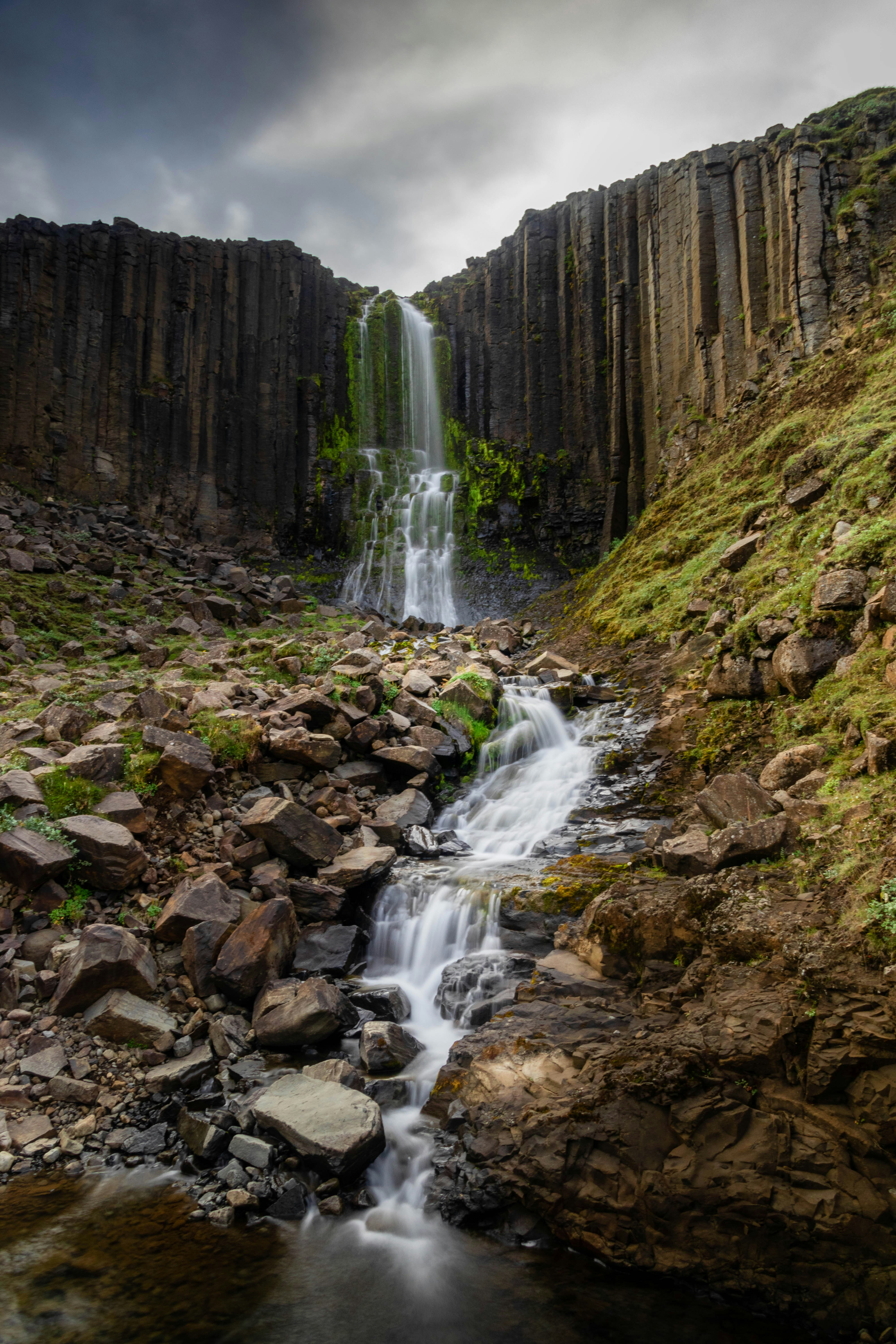 A small waterfall in the middle of a rocky area