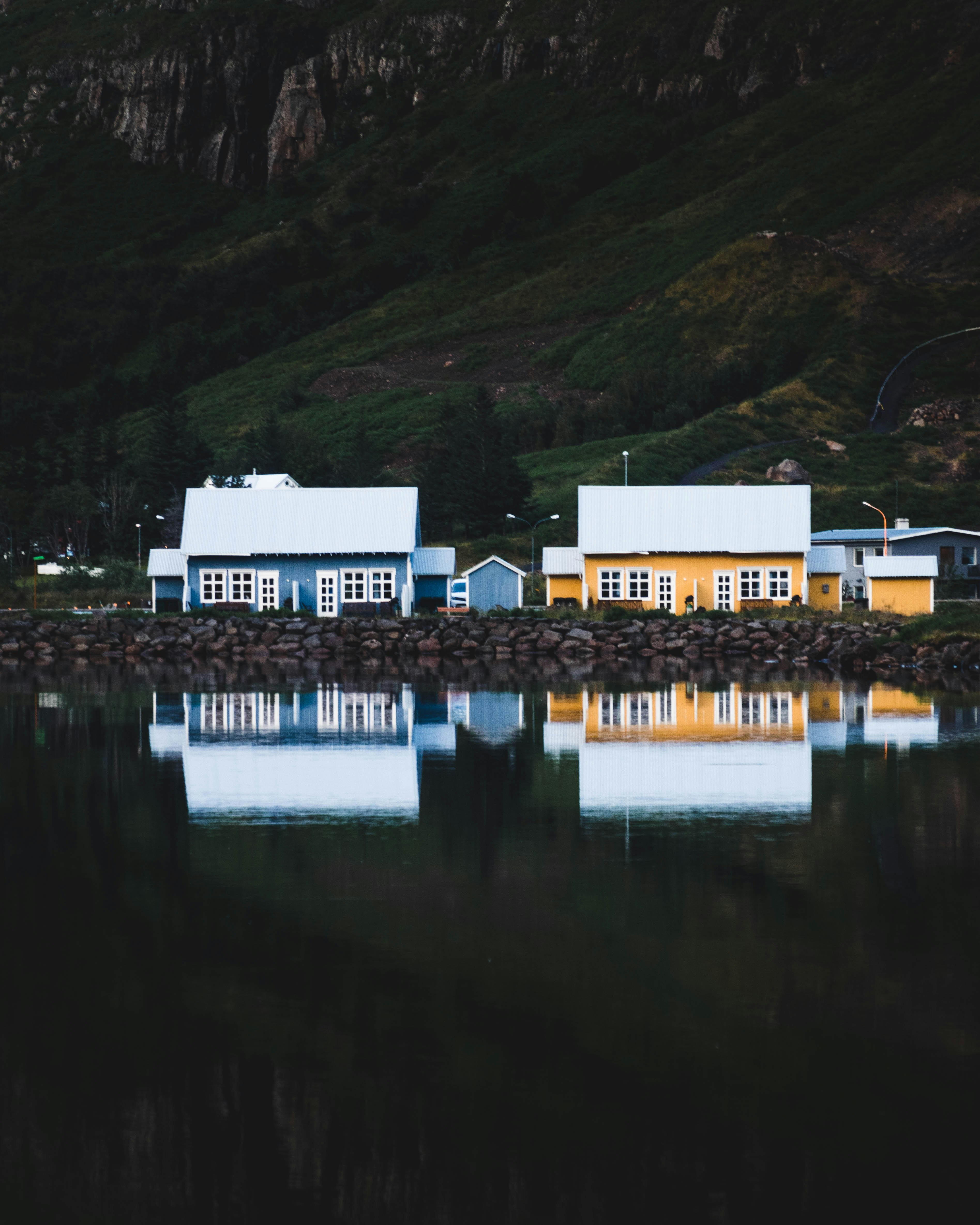 A couple of houses sitting on top of a lake
