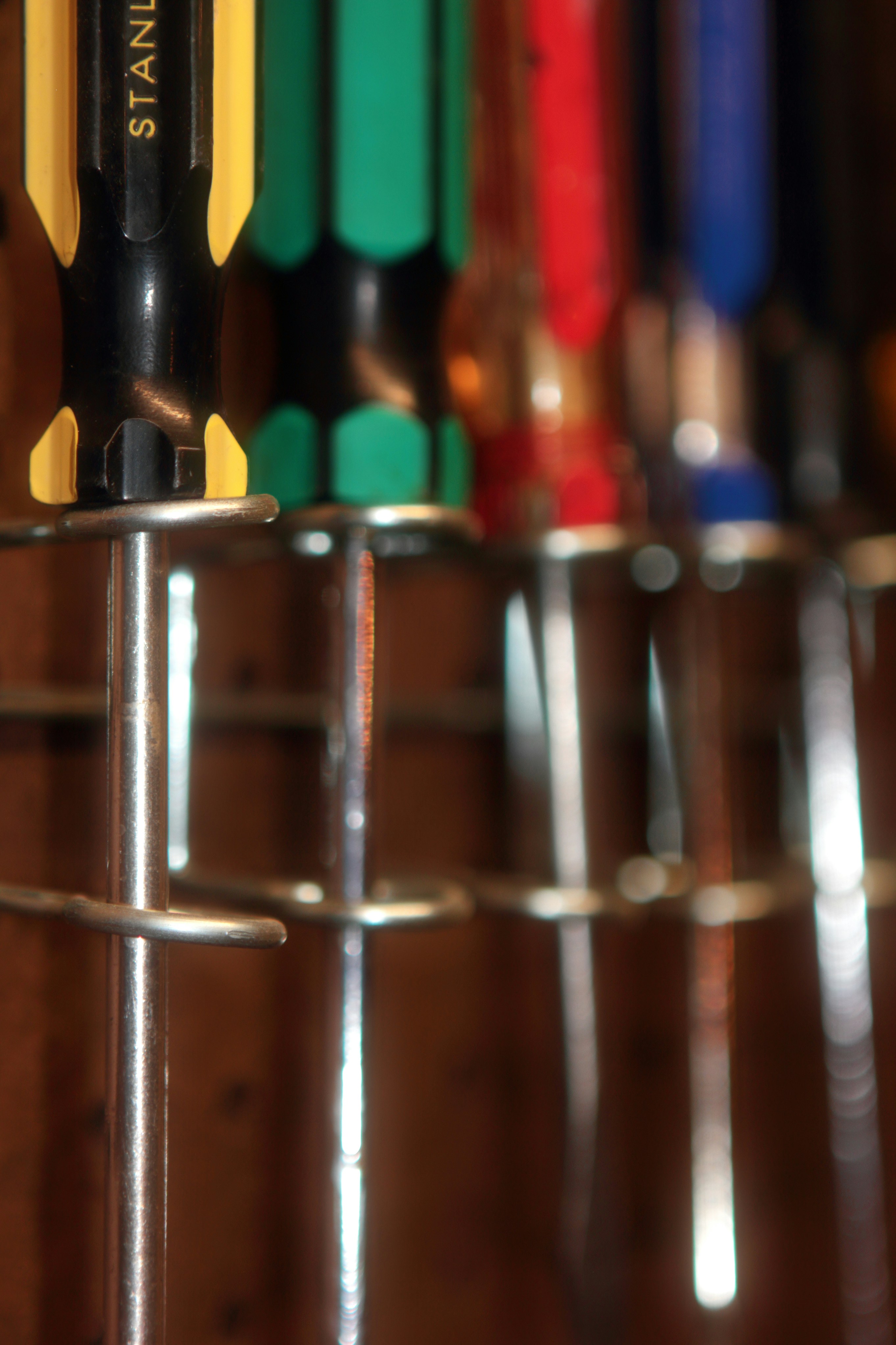 A bunch of pencils are lined up on a rack